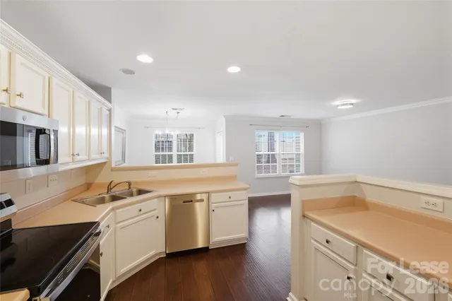 a kitchen that has a sink and a stove in it