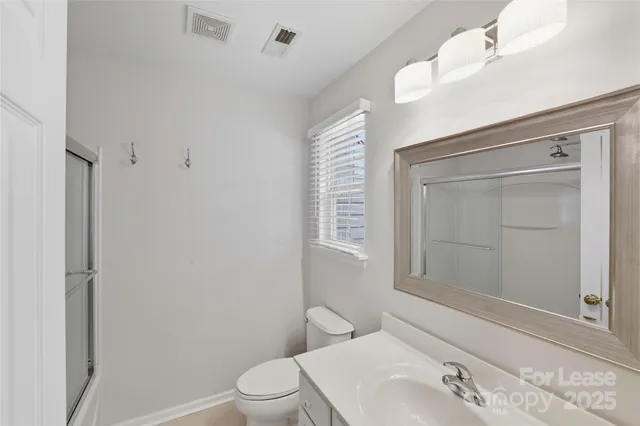 a bathroom with a toilet sink and shower