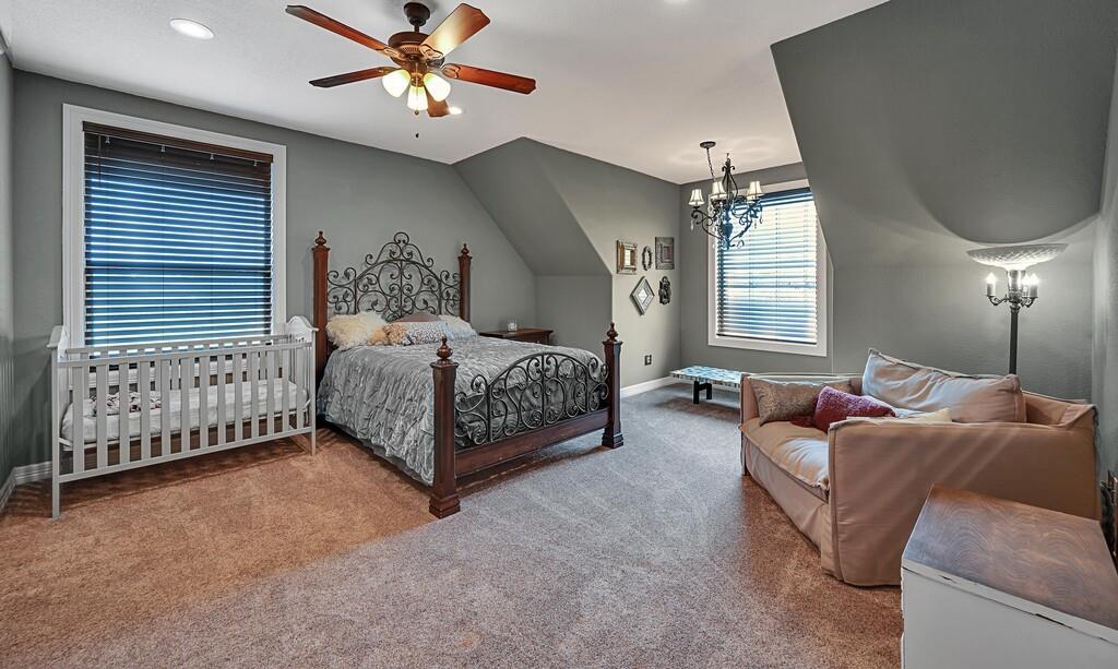 5004 Gholson Road Waco, TX 76705 - Photo 18 of 40 a living room with a bed furniture chandelier and a window