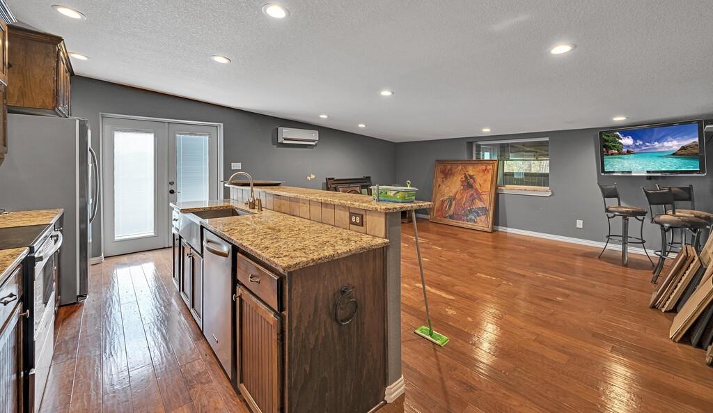 5004 Gholson Road Waco, TX 76705 - Photo 30 of 40 a kitchen with stainless steel appliances granite countertop a stove and a refrigerator