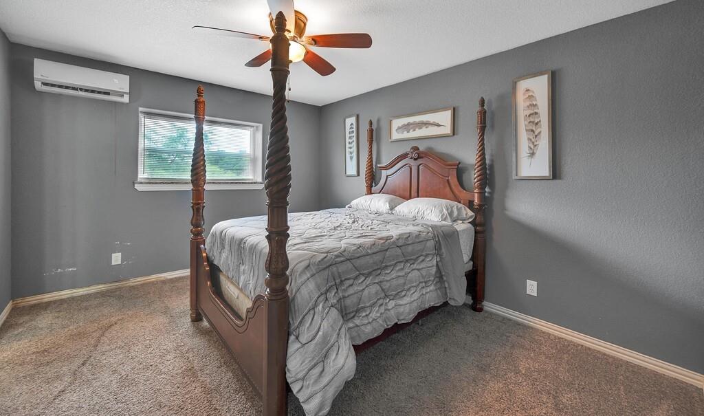5004 Gholson Road Waco, TX 76705 - Photo 31 of 40 a bedroom with a bed and a chandelier