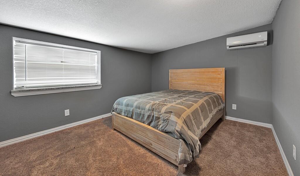 5004 Gholson Road Waco, TX 76705 - Photo 32 of 40 a bedroom with a bed and window