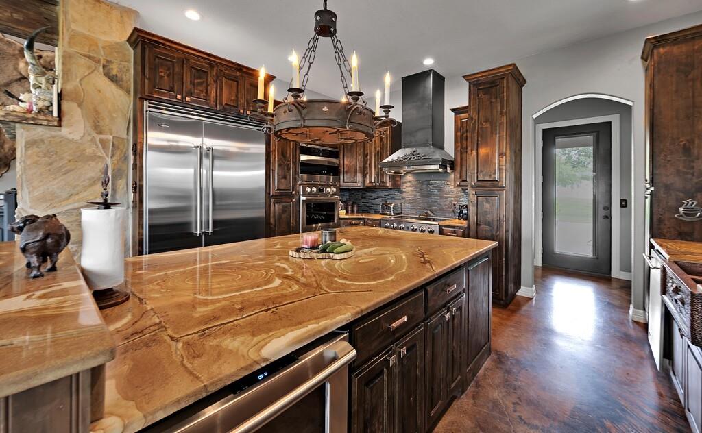 5004 Gholson Road Waco, TX 76705 - Photo 8 of 40 a kitchen with stainless steel appliances granite countertop a sink a refrigerator and a stove