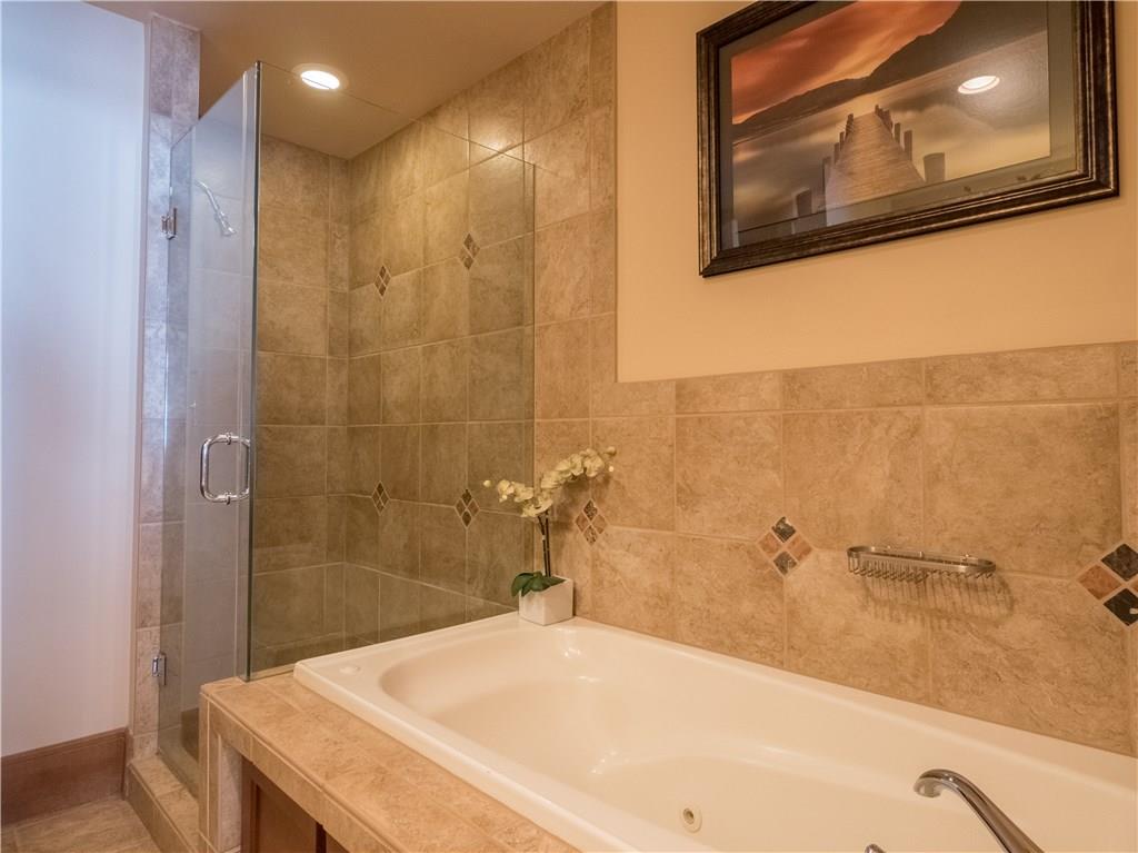 280 Trailhead Drive, Unit 3020 Keystone, CO 80435 - Photo 23 of 24 a bathroom with a bathtub and a shower
