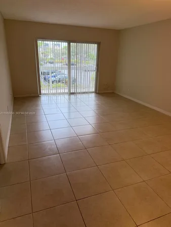 a view of an empty room and a window
