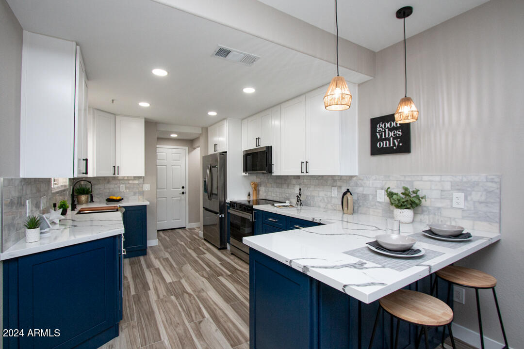 7710 East Gainey Ranch Road, Unit 137 Scottsdale, AZ 85258 - Photo 1 of 56 a kitchen with a sink refrigerator and microwave