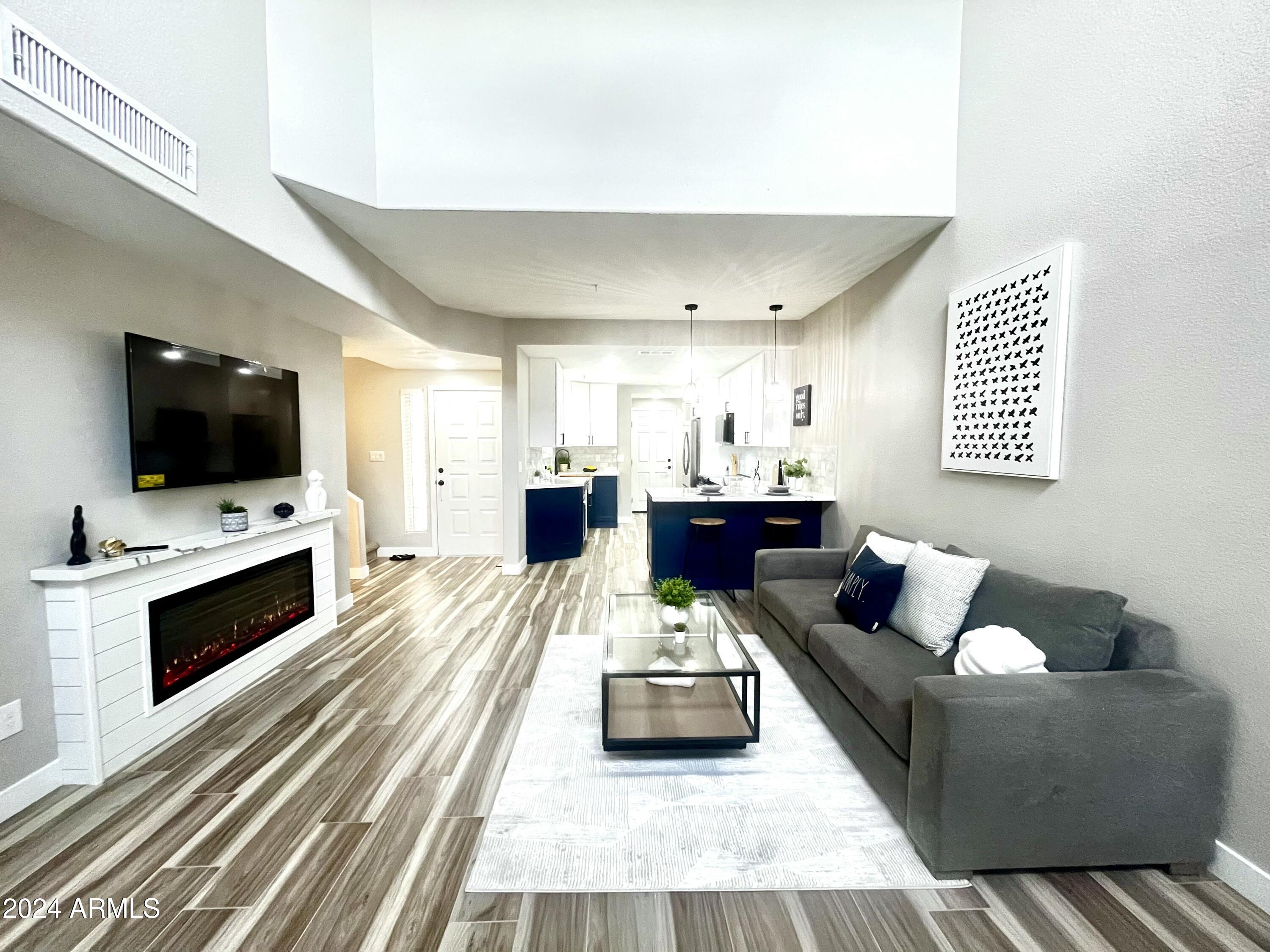 7710 East Gainey Ranch Road, Unit 137 Scottsdale, AZ 85258 - Photo 12 of 56 a living room with furniture and a flat screen tv