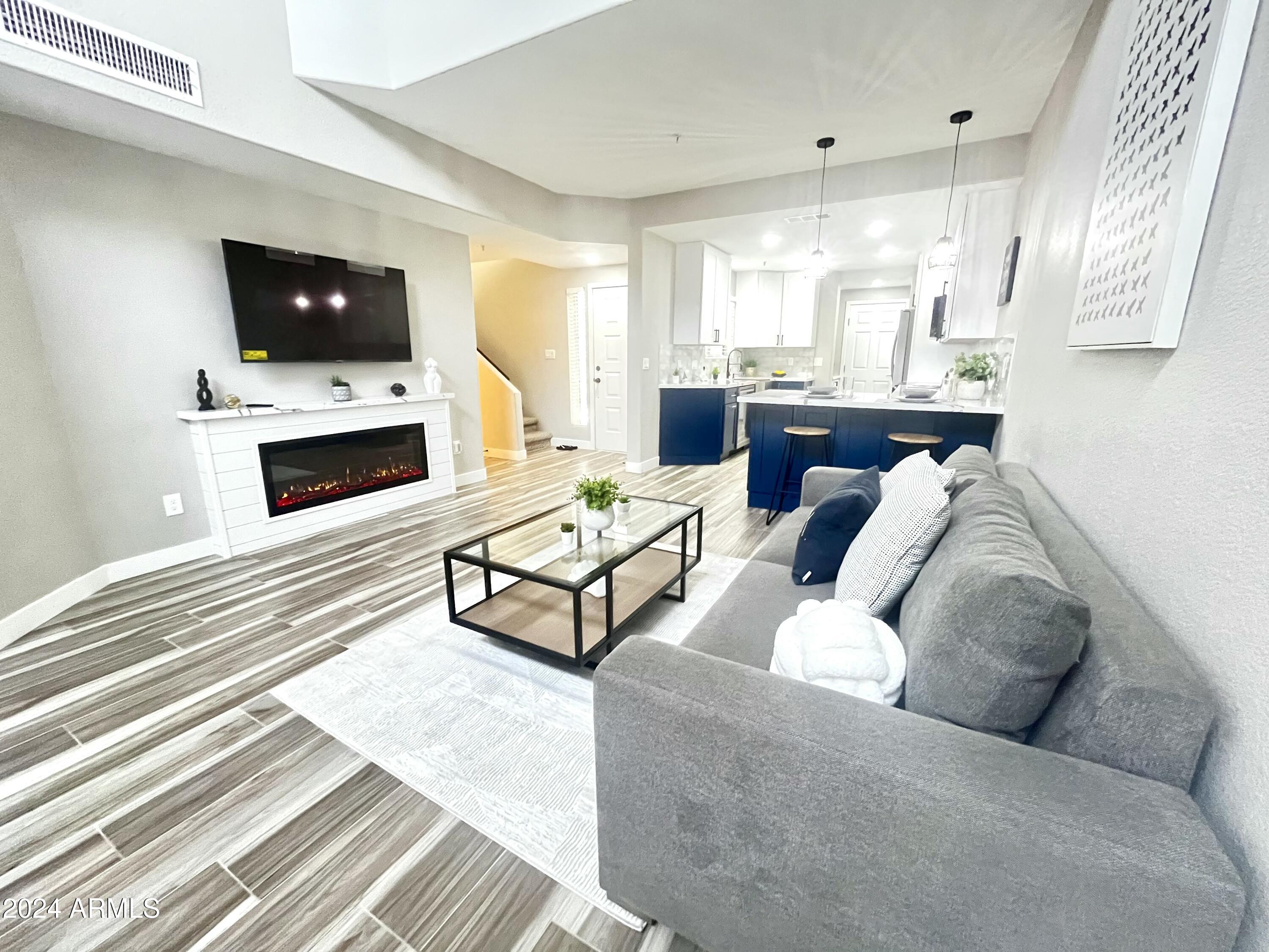 7710 East Gainey Ranch Road, Unit 137 Scottsdale, AZ 85258 - Photo 13 of 56 a living room with furniture and a fireplace