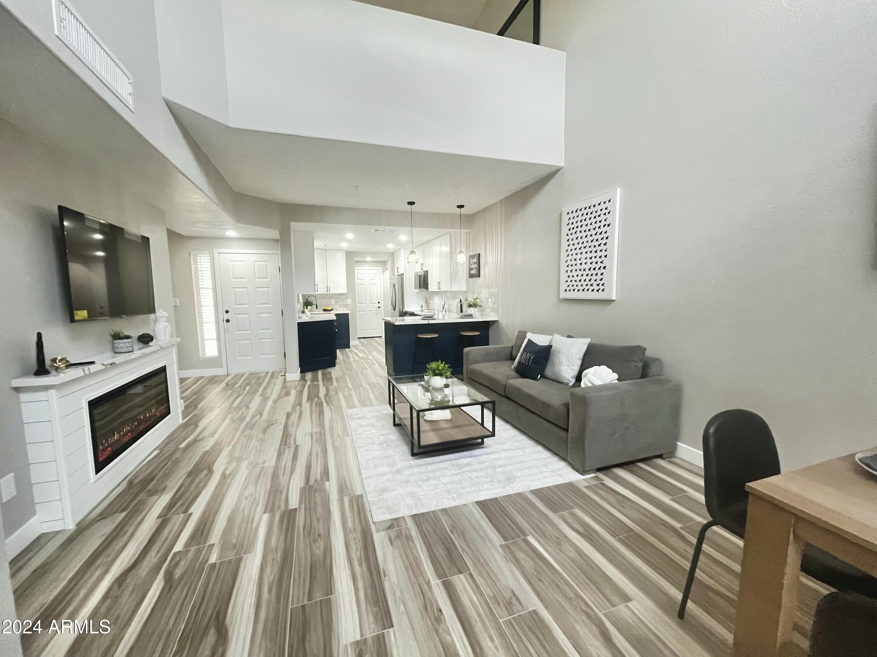 7710 East Gainey Ranch Road, Unit 137 Scottsdale, AZ 85258 - Photo 14 of 56 a living room with furniture and a flat screen tv