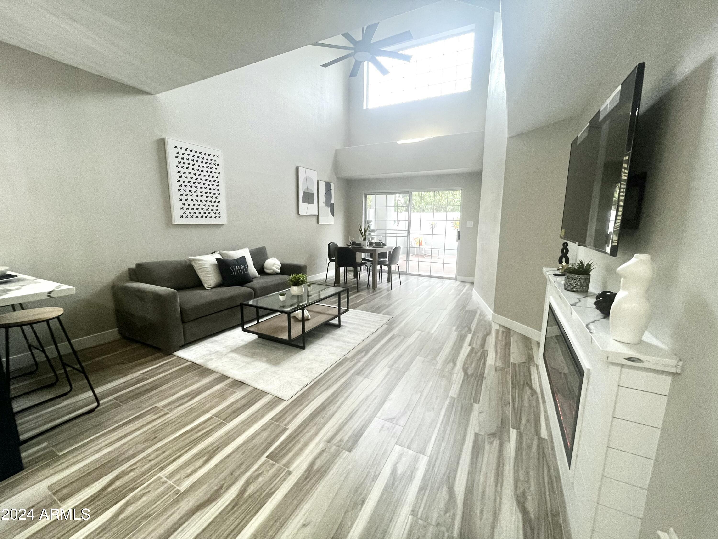 7710 East Gainey Ranch Road, Unit 137 Scottsdale, AZ 85258 - Photo 16 of 56 a living room with furniture and a flat screen tv