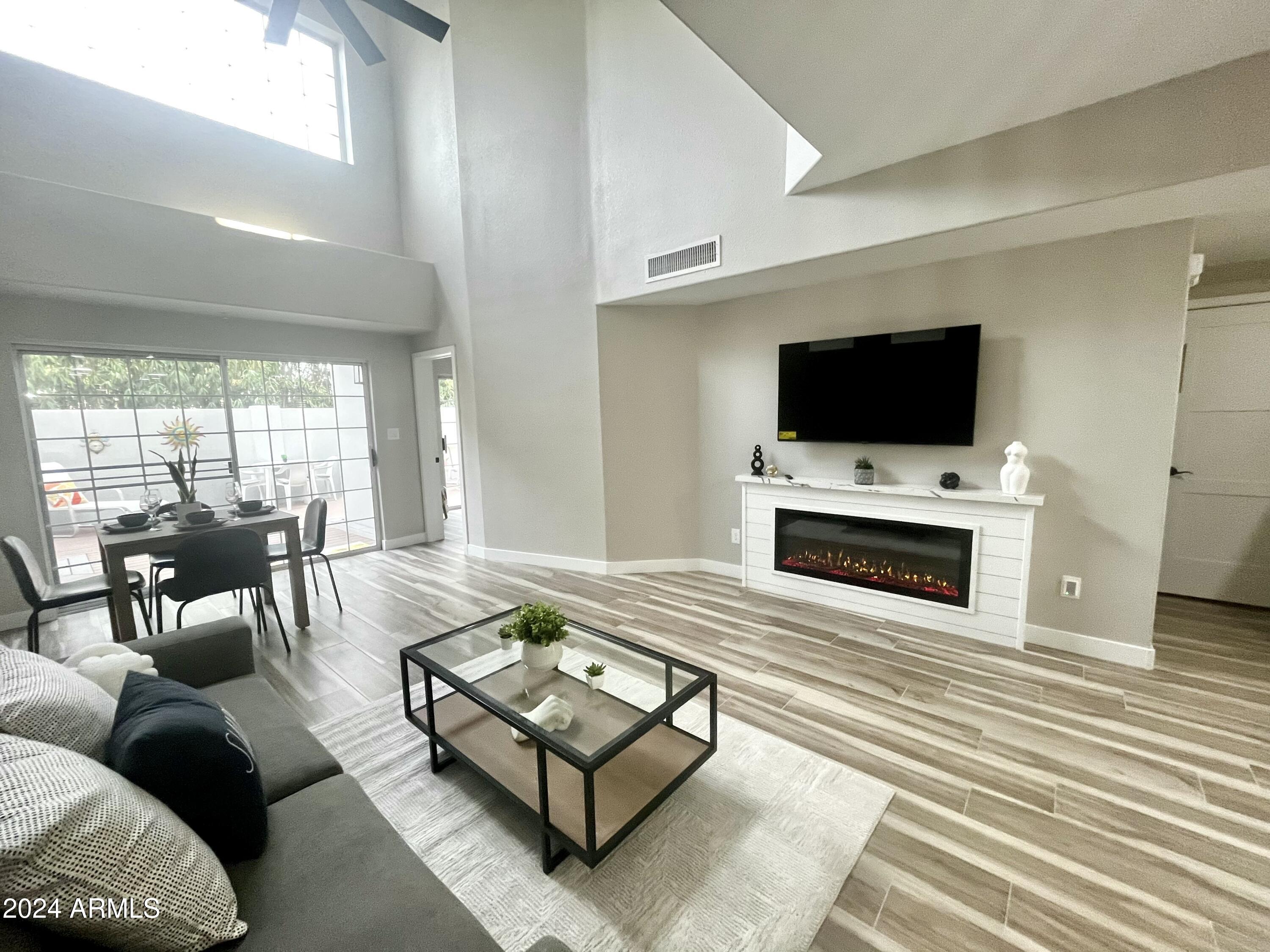 7710 East Gainey Ranch Road, Unit 137 Scottsdale, AZ 85258 - Photo 17 of 56 a living room with furniture and a flat screen tv