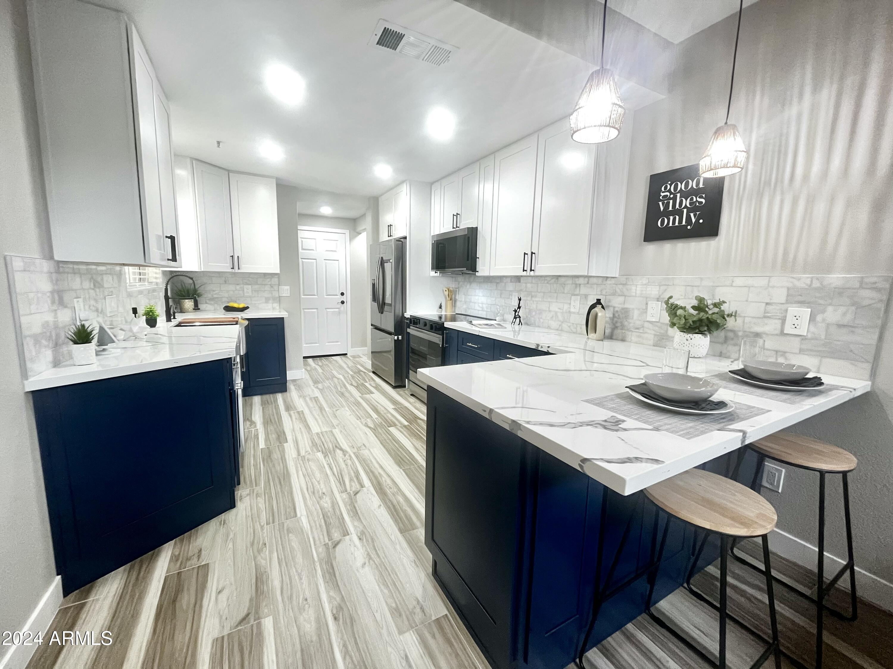 7710 East Gainey Ranch Road, Unit 137 Scottsdale, AZ 85258 - Photo 2 of 56 a kitchen with sink and stove