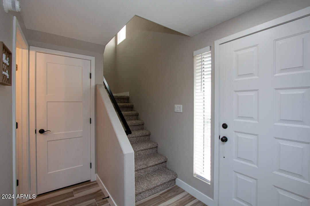 7710 East Gainey Ranch Road, Unit 137 Scottsdale, AZ 85258 - Photo 28 of 56 a view of a hallway with entryway and stairs