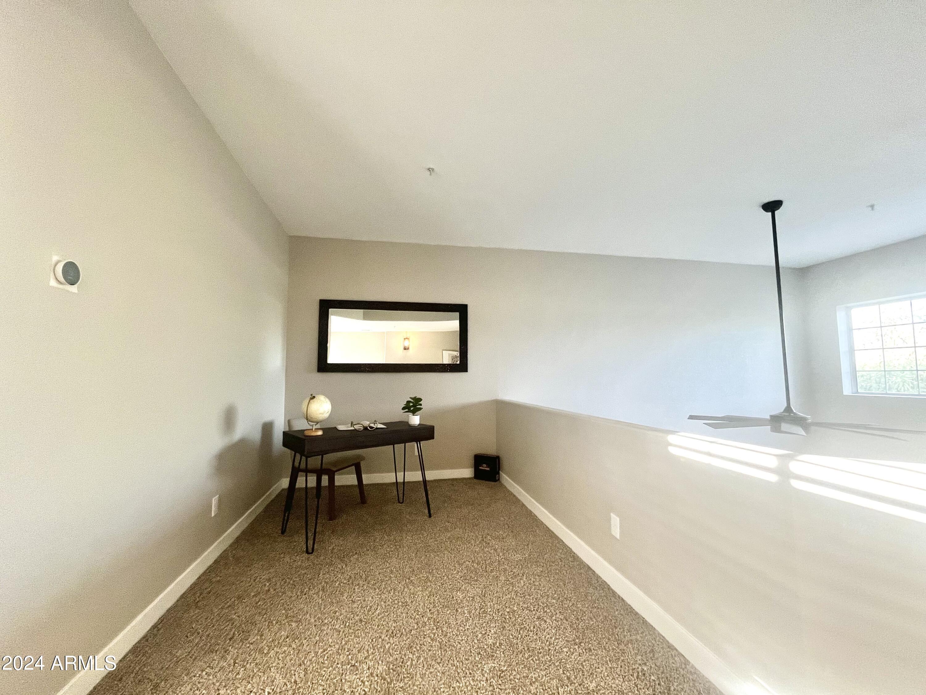 7710 East Gainey Ranch Road, Unit 137 Scottsdale, AZ 85258 - Photo 30 of 56 a view of a workspace with furniture and a window