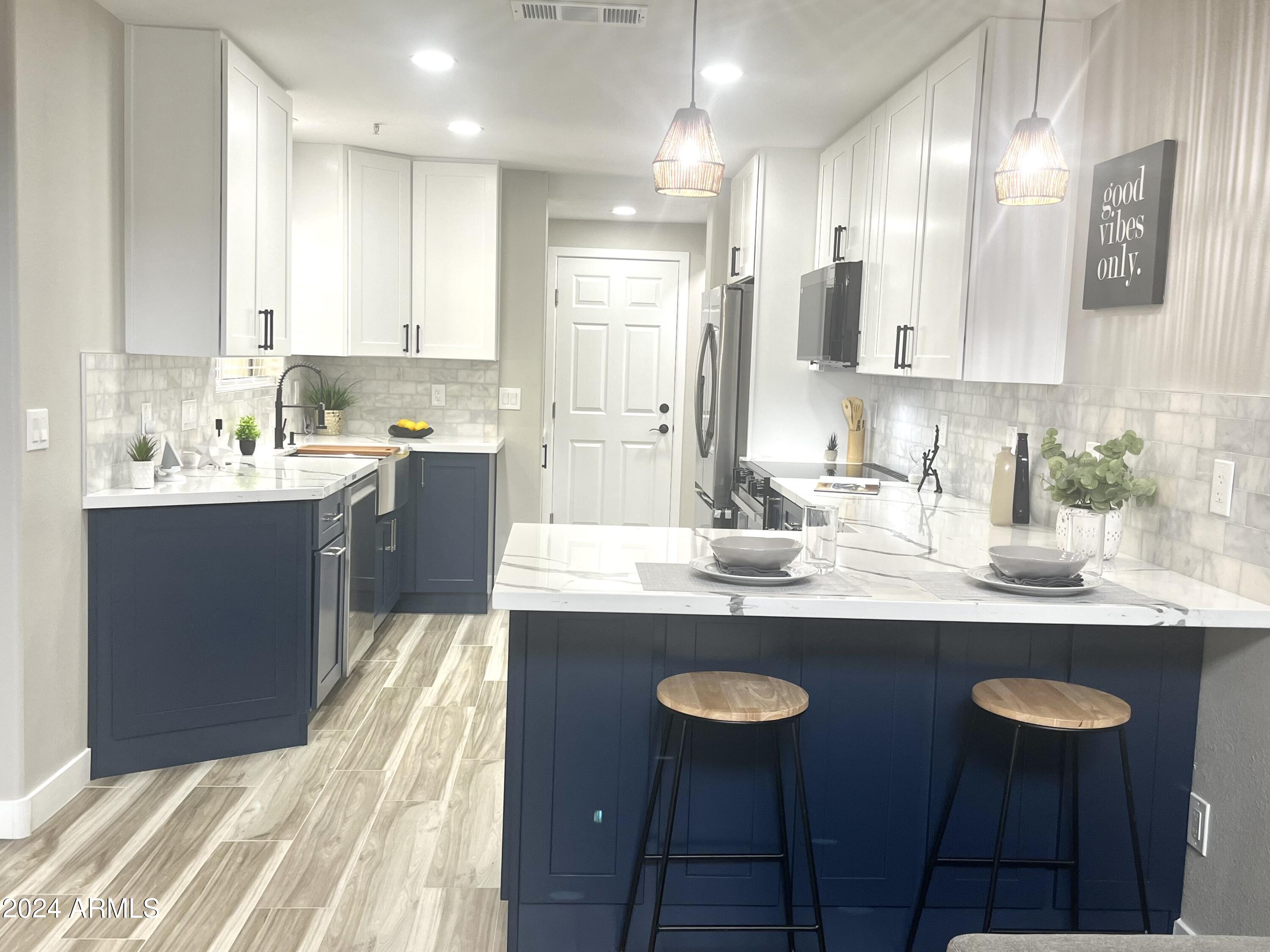 7710 East Gainey Ranch Road, Unit 137 Scottsdale, AZ 85258 - Photo 3 of 56 a kitchen with a sink and cabinets