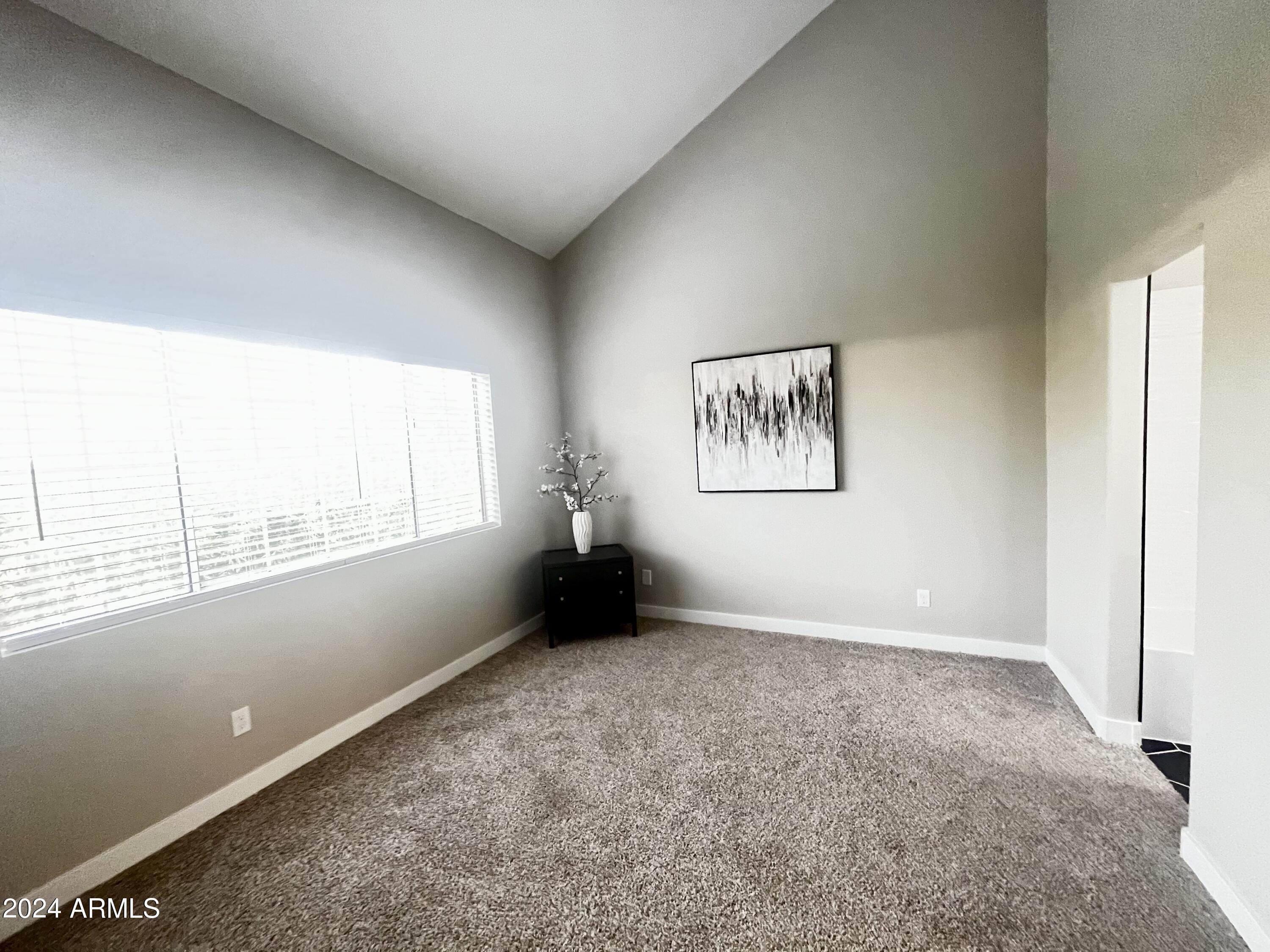 7710 East Gainey Ranch Road, Unit 137 Scottsdale, AZ 85258 - Photo 32 of 56 an empty room with windows
