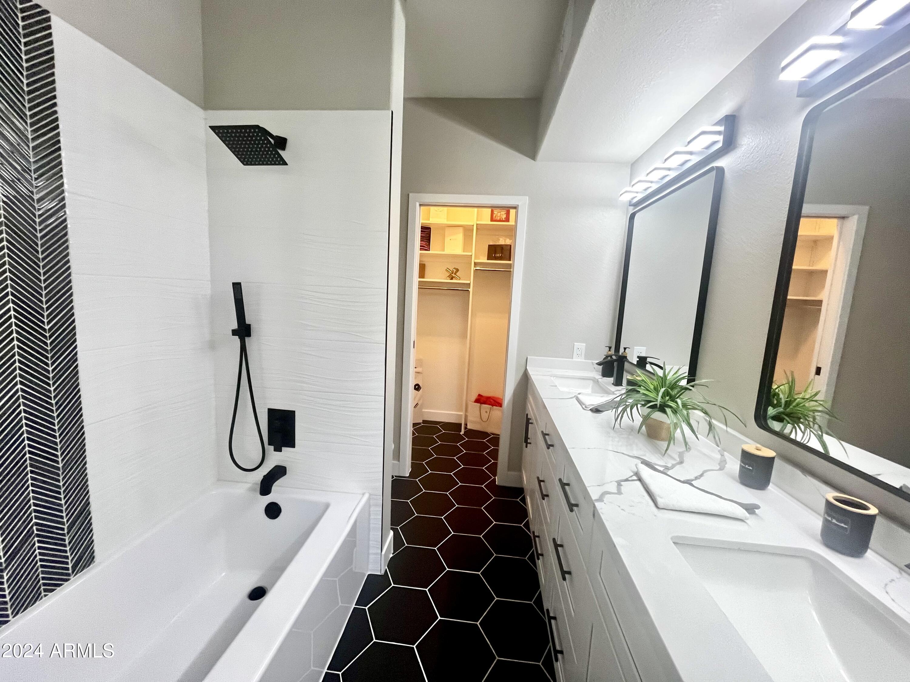 7710 East Gainey Ranch Road, Unit 137 Scottsdale, AZ 85258 - Photo 35 of 56 a bathroom with a double vanity sink and mirror