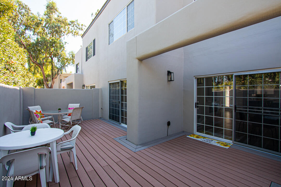 7710 East Gainey Ranch Road, Unit 137 Scottsdale, AZ 85258 - Photo 40 of 56 a view of a deck with wooden floor and yard