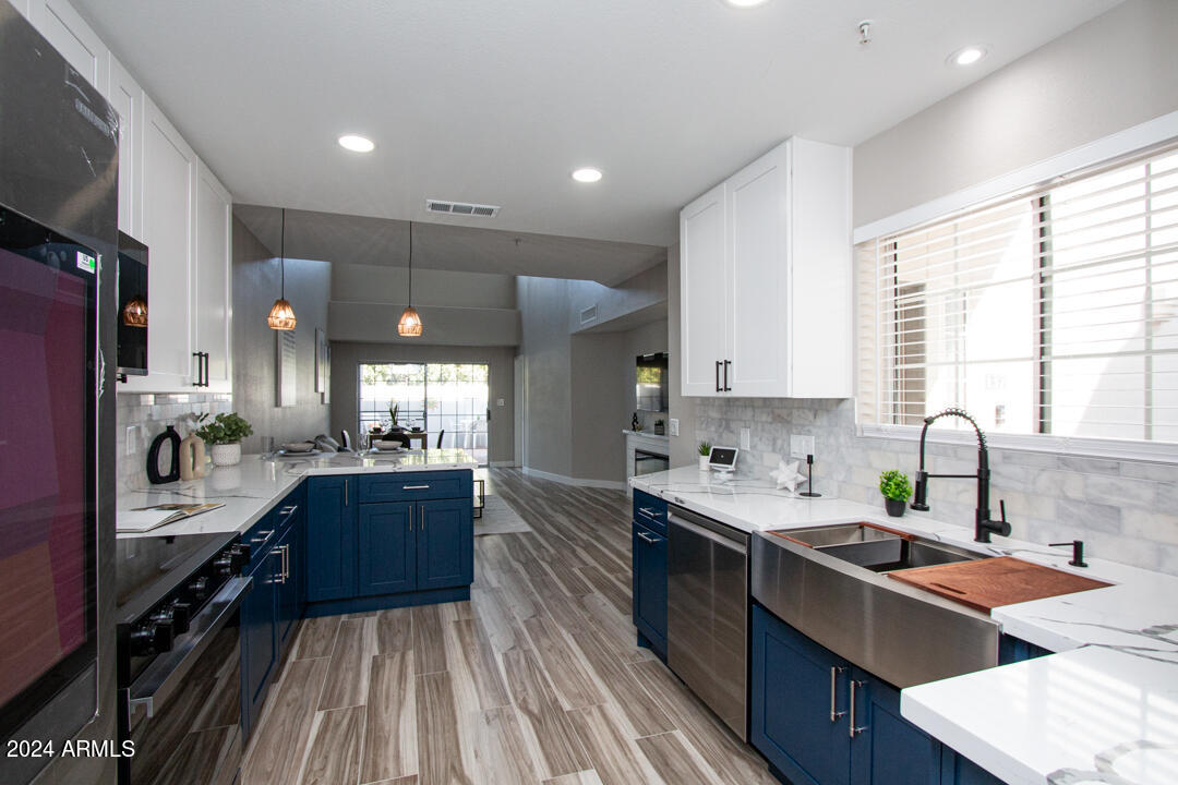7710 East Gainey Ranch Road, Unit 137 Scottsdale, AZ 85258 - Photo 4 of 56 a large kitchen with lots of counter space a sink appliances and cabinets