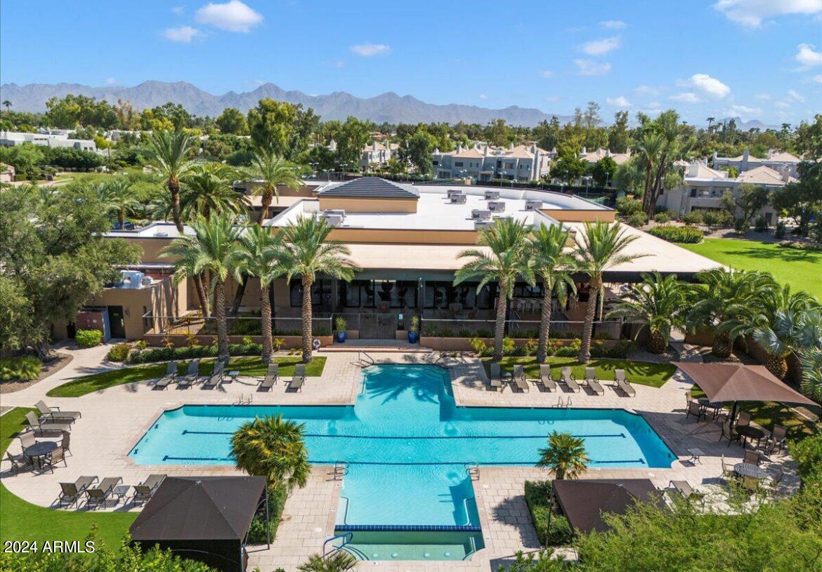 7710 East Gainey Ranch Road, Unit 137 Scottsdale, AZ 85258 - Photo 49 of 56 an aerial view of a house with swimming pool and a yard