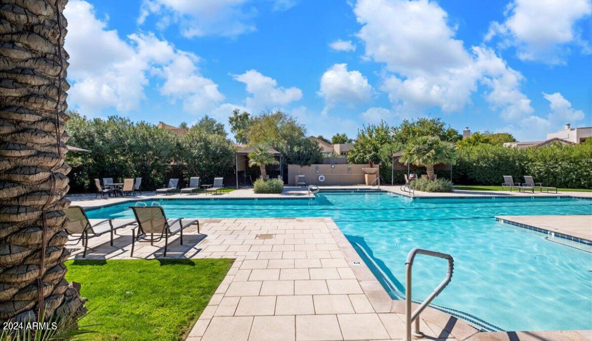 7710 East Gainey Ranch Road, Unit 137 Scottsdale, AZ 85258 - Photo 50 of 56 a view of a swimming pool with a yard