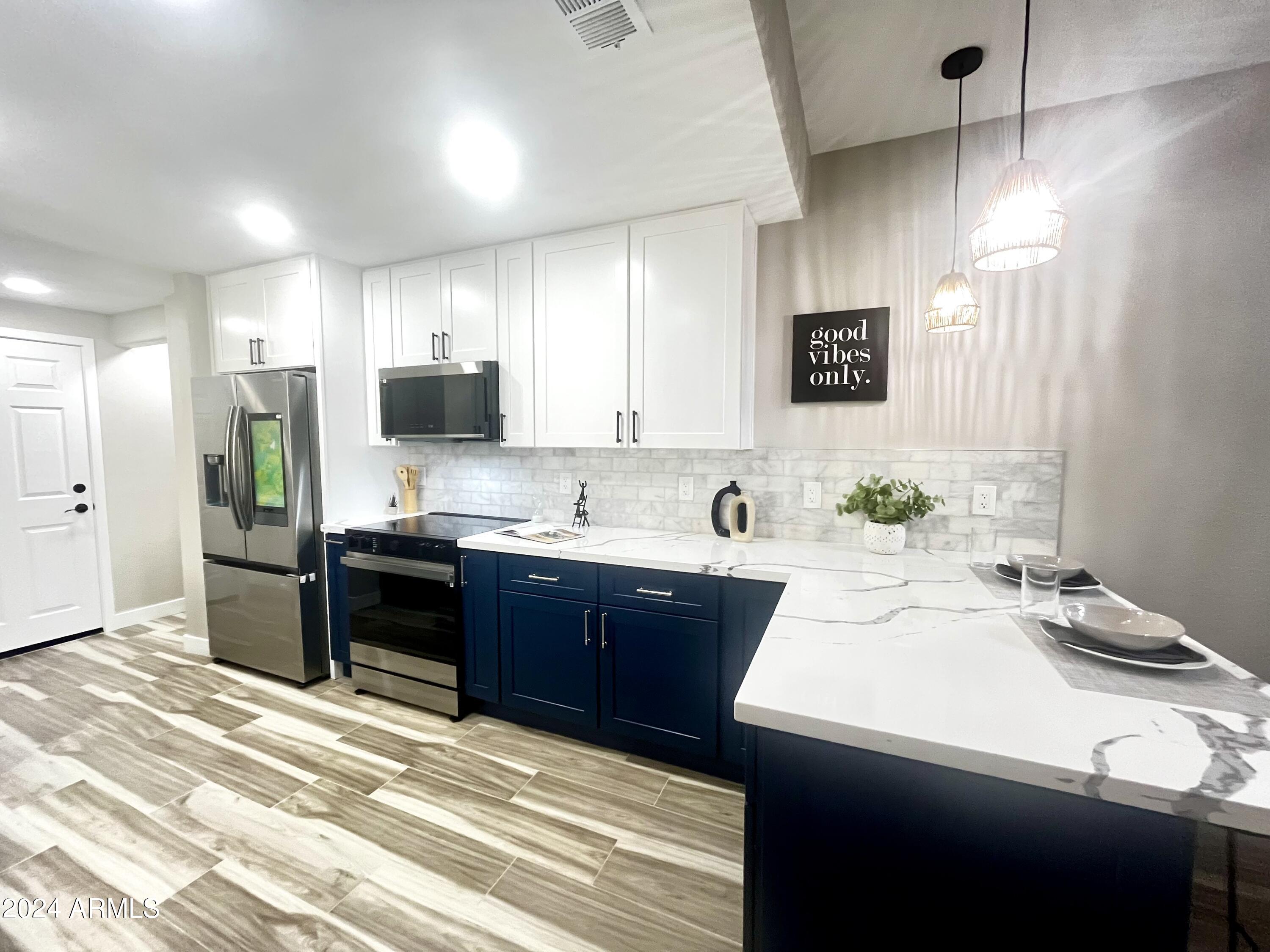 7710 East Gainey Ranch Road, Unit 137 Scottsdale, AZ 85258 - Photo 5 of 56 a kitchen with a refrigerator and a sink