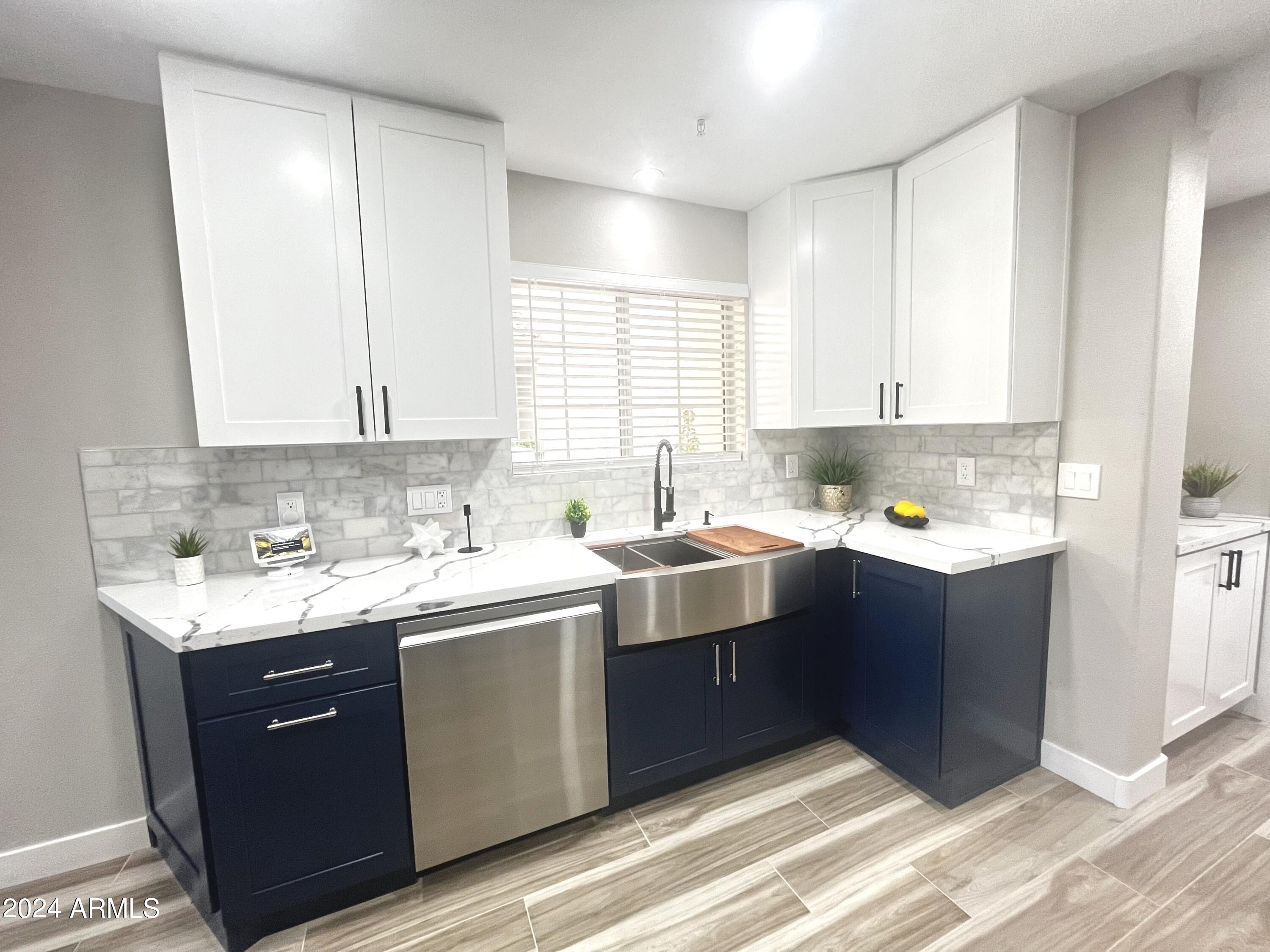 7710 East Gainey Ranch Road, Unit 137 Scottsdale, AZ 85258 - Photo 6 of 56 a kitchen with a sink cabinets and window