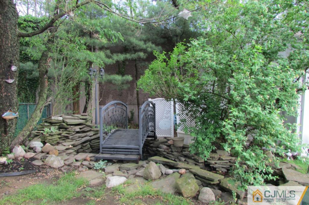 17 Gage Road East Brunswick, NJ 08816 - Photo 16 of 24 a view of a chairs and fire pit in a backyard