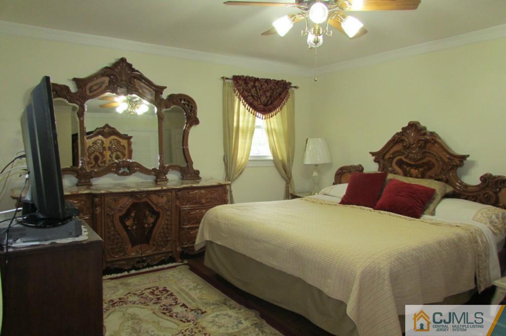 17 Gage Road East Brunswick, NJ 08816 - Photo 20 of 24 a bedroom with a bed and a mirror