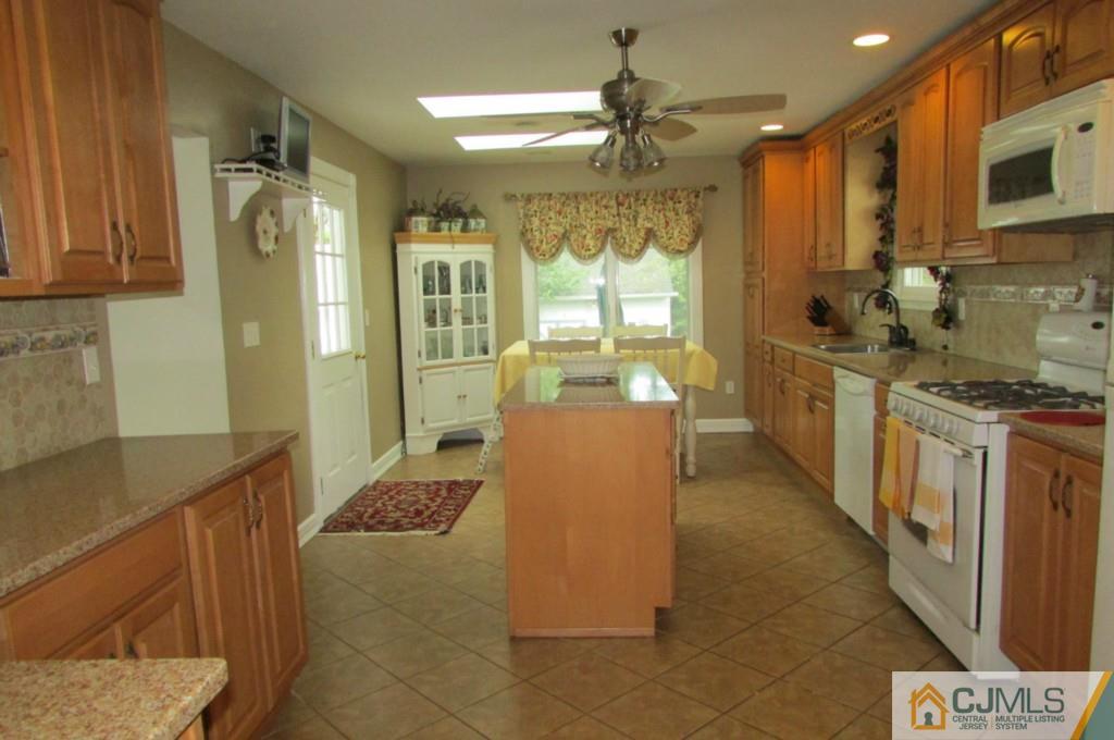 17 Gage Road East Brunswick, NJ 08816 - Photo 3 of 24 a kitchen with stainless steel appliances granite countertop a refrigerator and a stove
