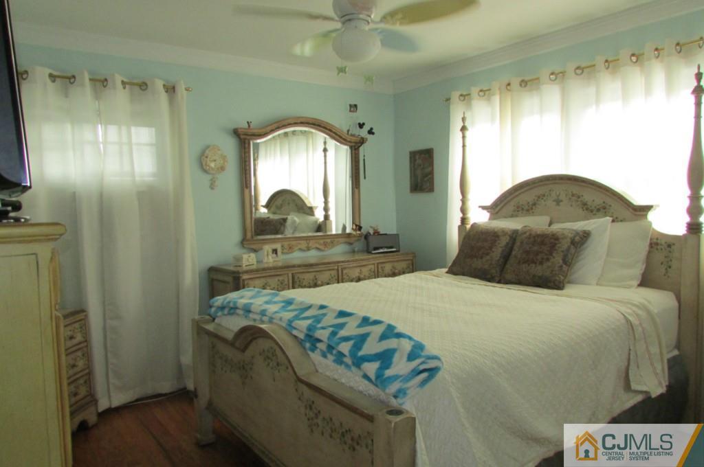 17 Gage Road East Brunswick, NJ 08816 - Photo 22 of 24 a bedroom with a bed and a mirror on dresser