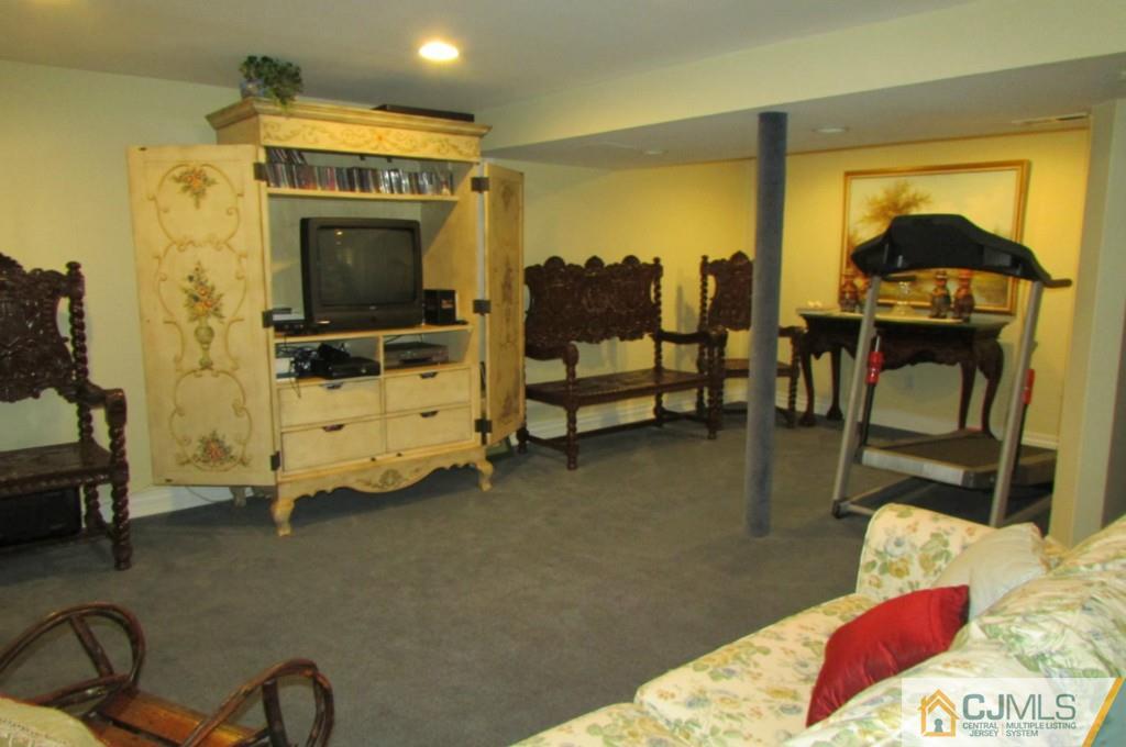 17 Gage Road East Brunswick, NJ 08816 - Photo 24 of 24 a living room with furniture and a flat screen tv