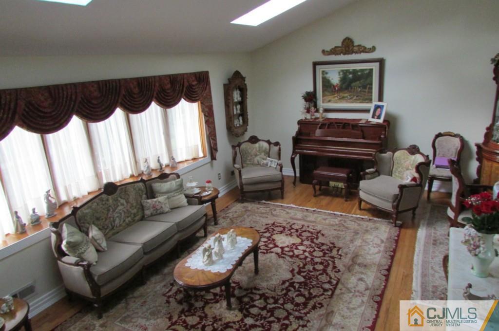 17 Gage Road East Brunswick, NJ 08816 - Photo 7 of 24 a living room with furniture a piano and a rug