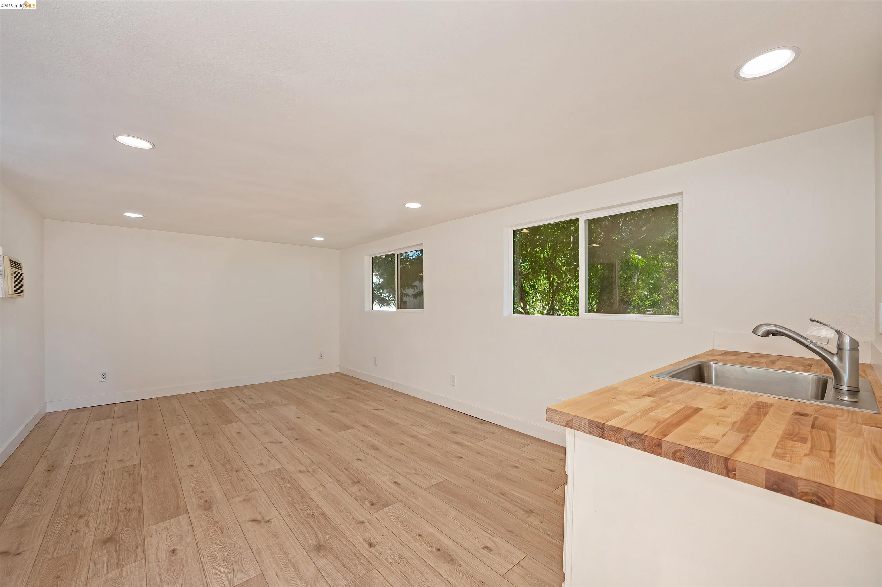 10474 Sheldon Road Elk Grove, CA 95624 - Photo 65 of 83 Bright interior space featuring wood-finish flooring, recessed lighting, and white walls