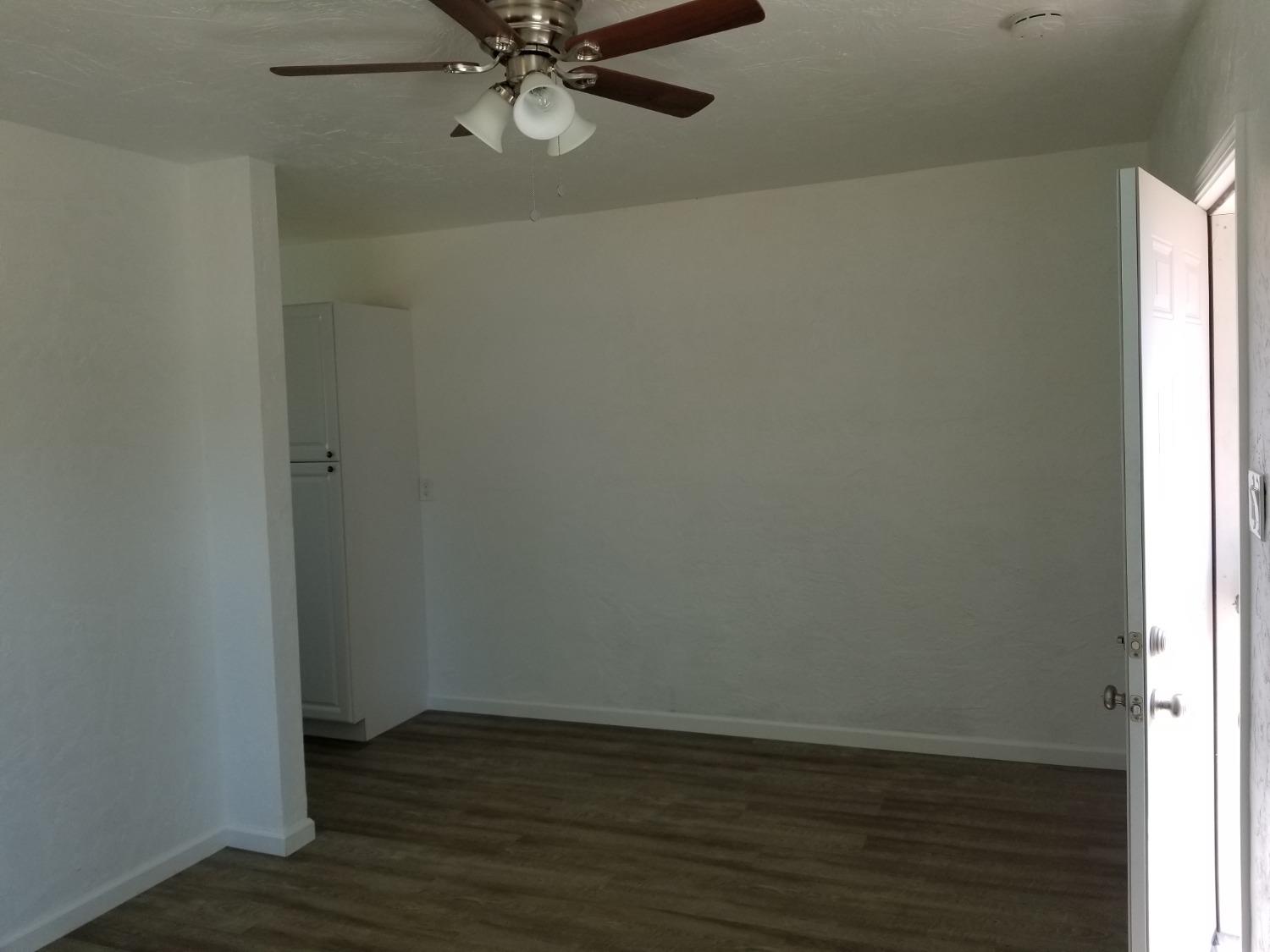 618 J Street Modesto, CA 95354 - Photo 16 of 38 a view of an empty room with wooden floor and a window