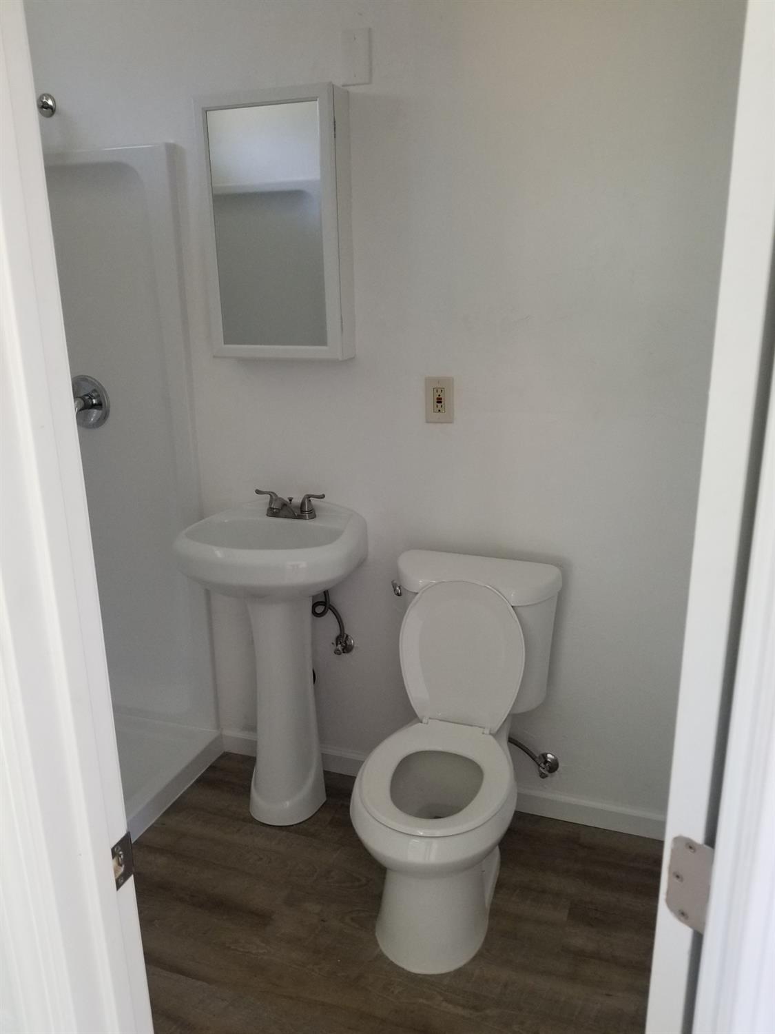 618 J Street Modesto, CA 95354 - Photo 19 of 38 a bathroom with a toilet sink and mirror