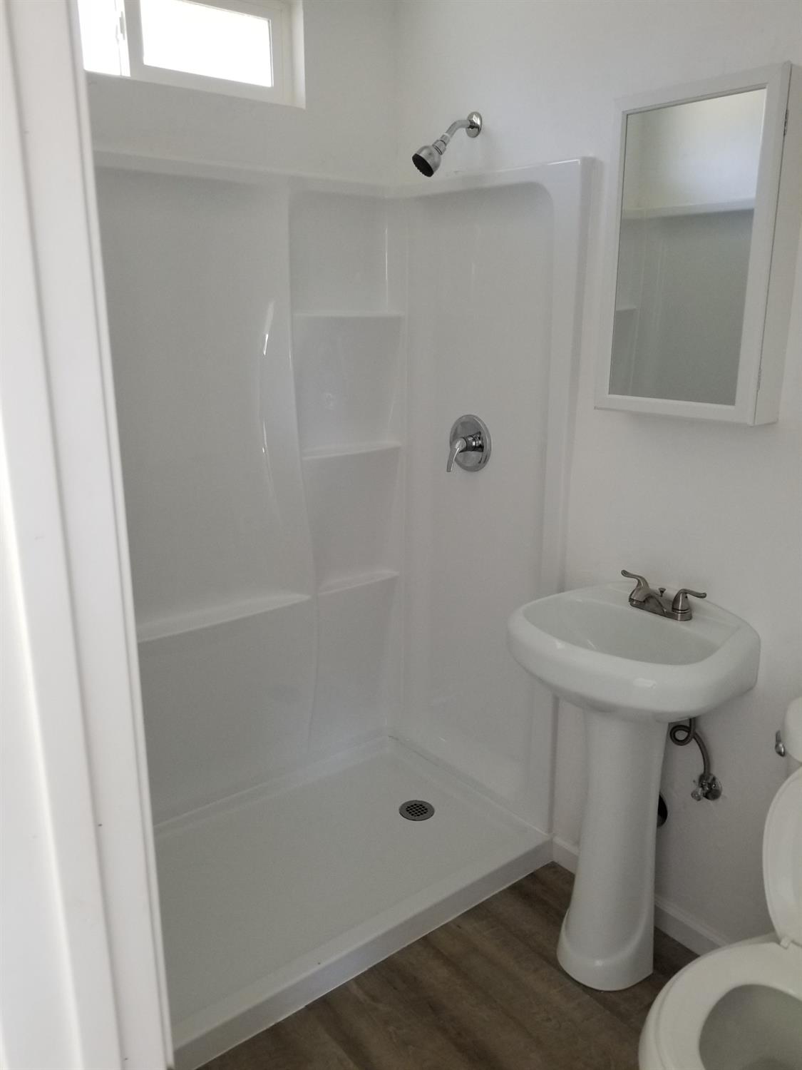 618 J Street Modesto, CA 95354 - Photo 20 of 38 a bathroom with a sink a toilet and shower