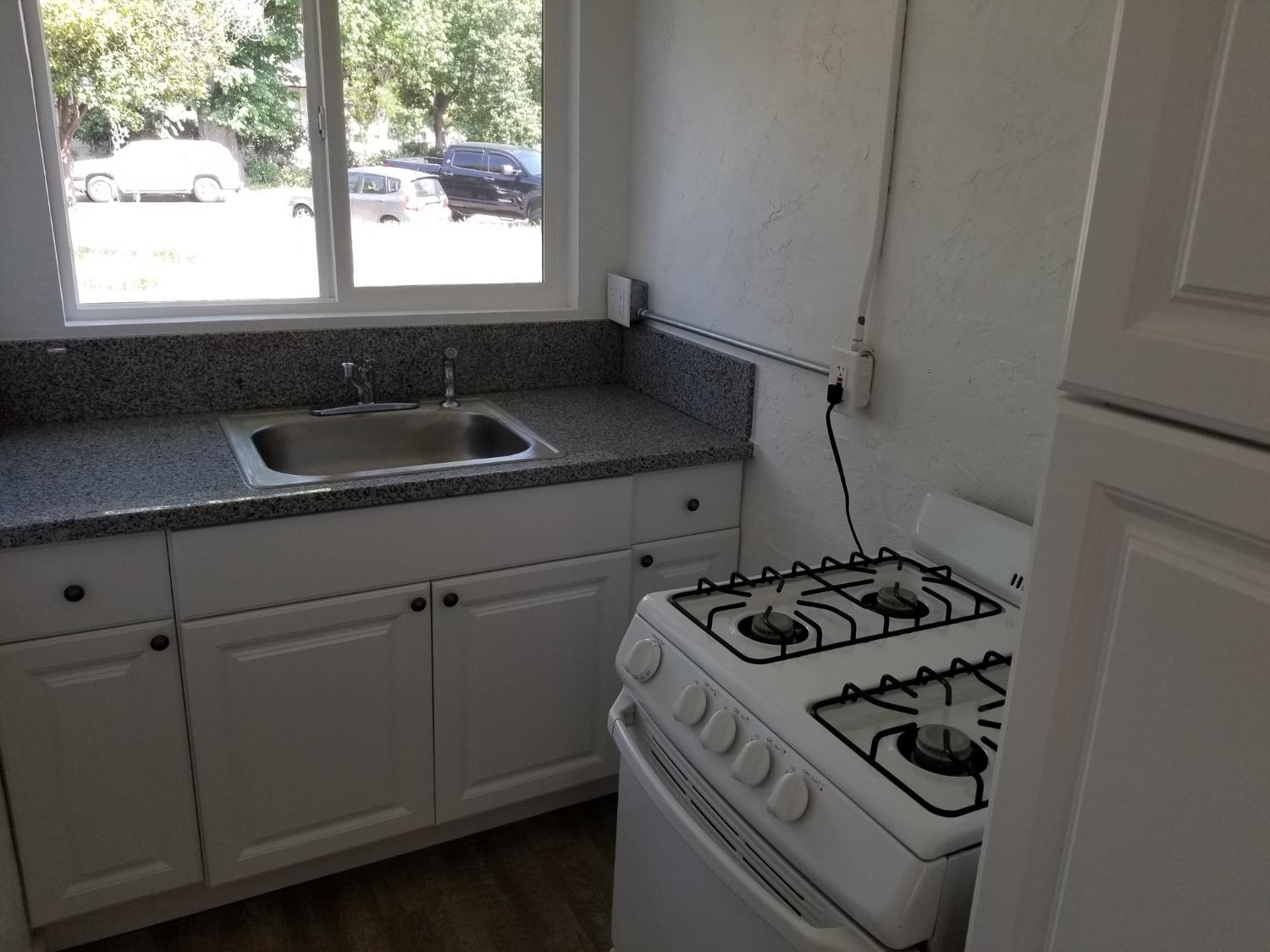 618 J Street Modesto, CA 95354 - Photo 21 of 38 a kitchen with a stove and a sink