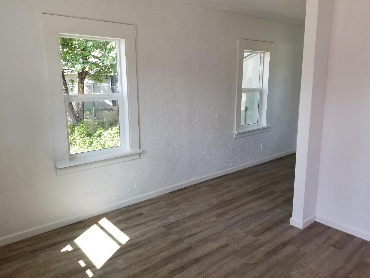 618 J Street Modesto, CA 95354 - Photo 24 of 38 an empty room with wooden floor and windows