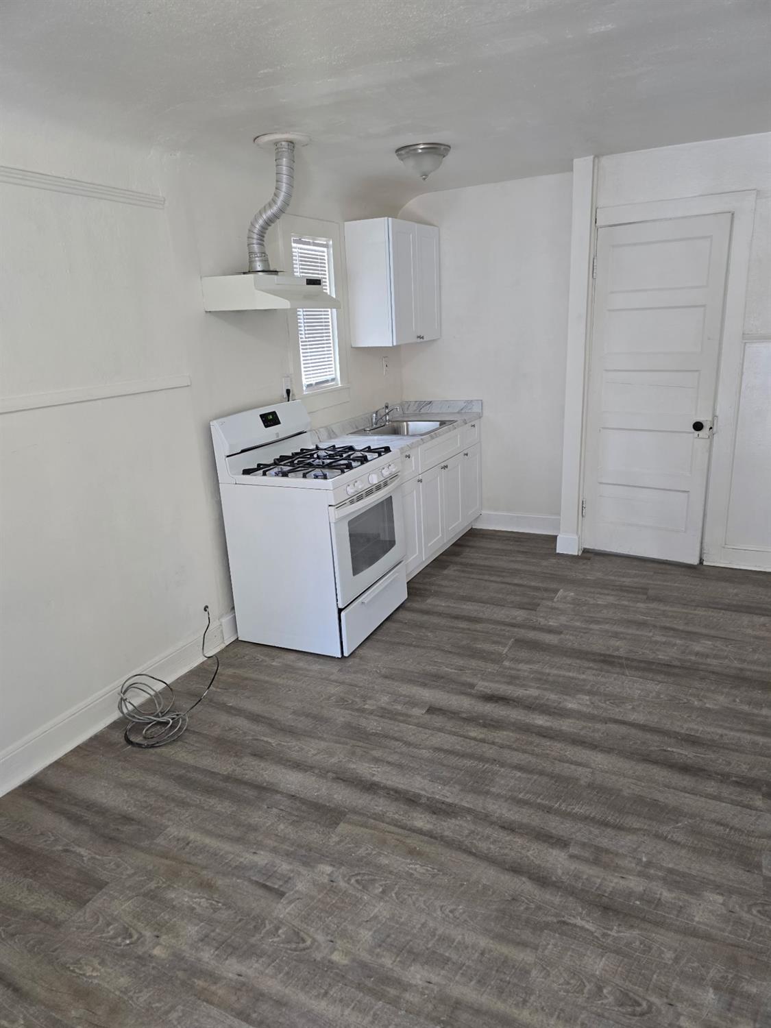 618 J Street Modesto, CA 95354 - Photo 25 of 38 a white kitchen with wooden floor
