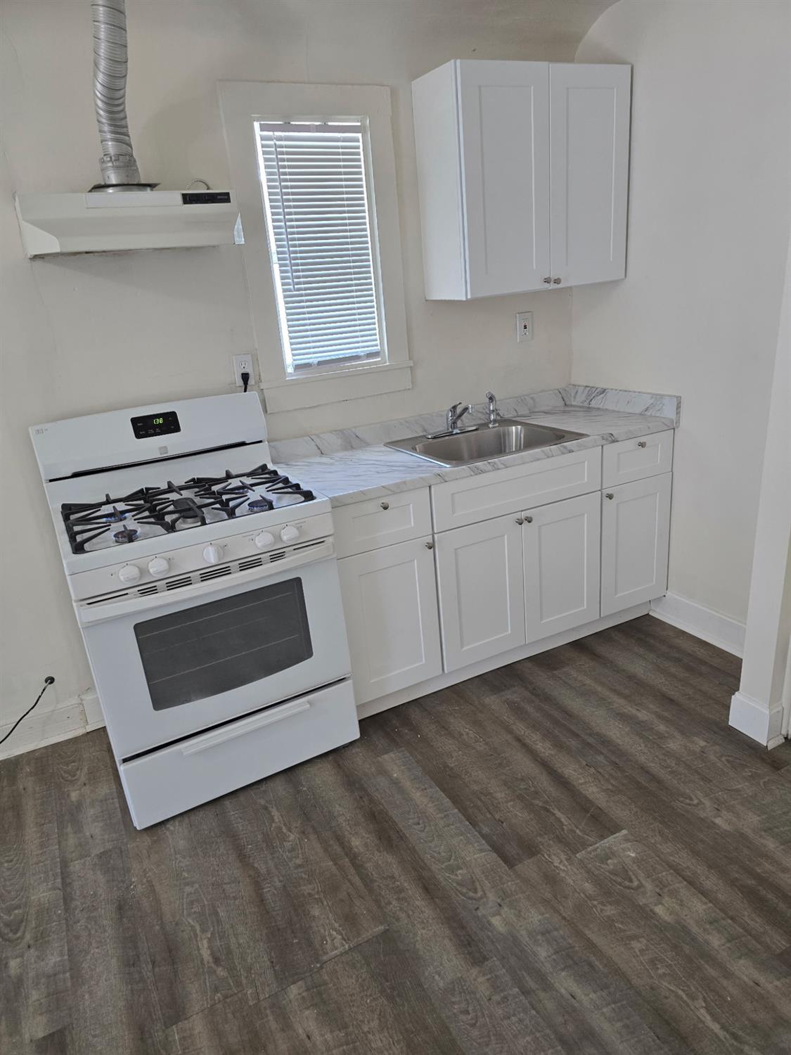 618 J Street Modesto, CA 95354 - Photo 26 of 38 a kitchen with granite countertop white cabinets and white stainless steel appliances