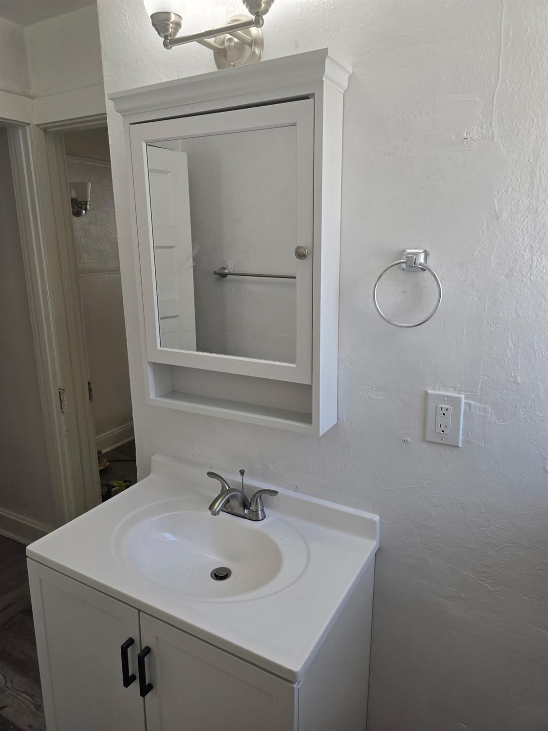 618 J Street Modesto, CA 95354 - Photo 27 of 38 a bathroom with a sink vanity and mirror