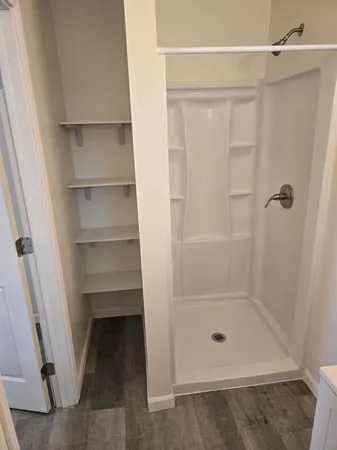 a bathroom with a glass shower door