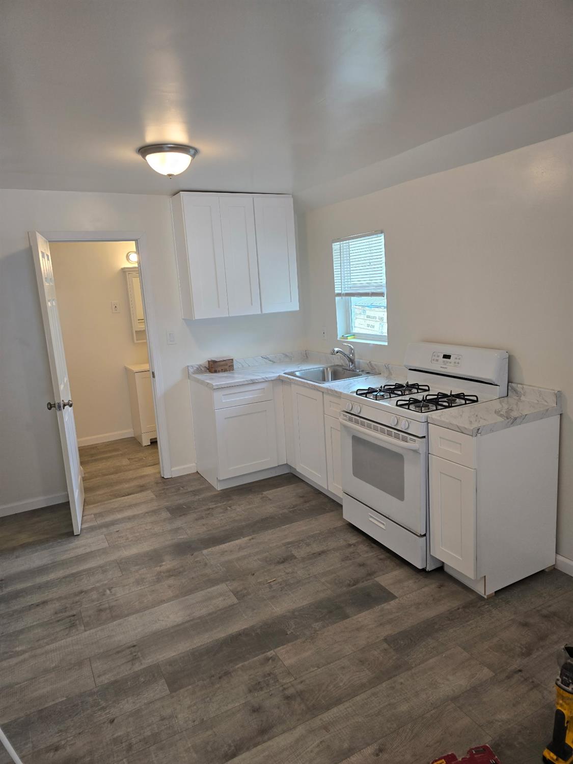 618 J Street Modesto, CA 95354 - Photo 29 of 38 a kitchen with white cabinets and white appliances