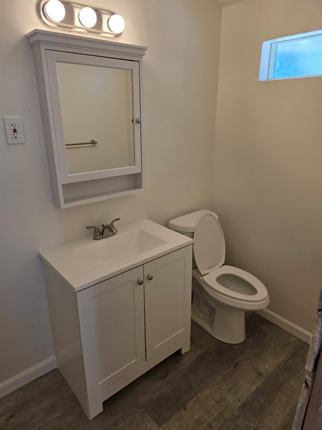 618 J Street Modesto, CA 95354 - Photo 33 of 38 a bathroom with a toilet sink and mirror
