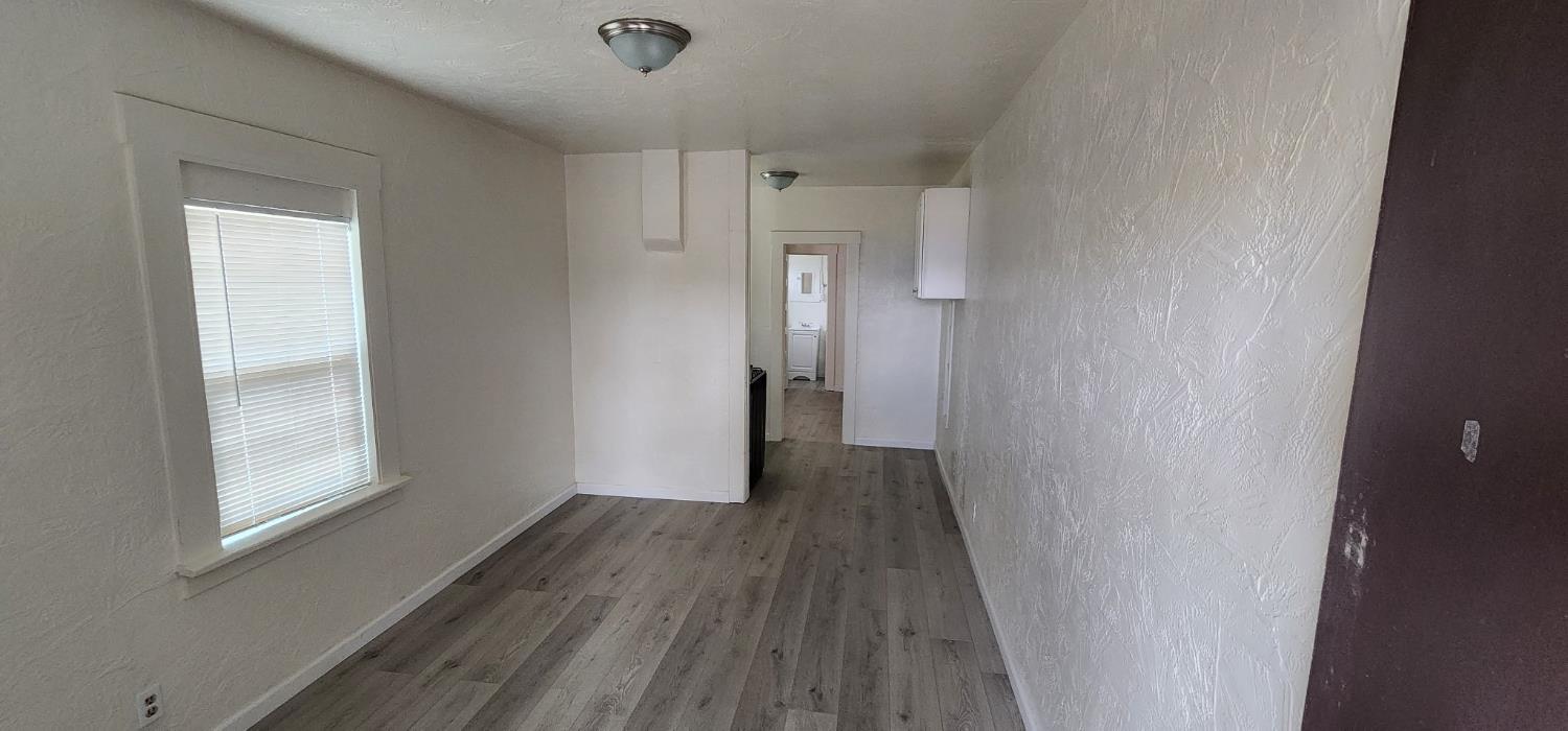 618 J Street Modesto, CA 95354 - Photo 34 of 38 a view of a hallway with wooden floor and a window