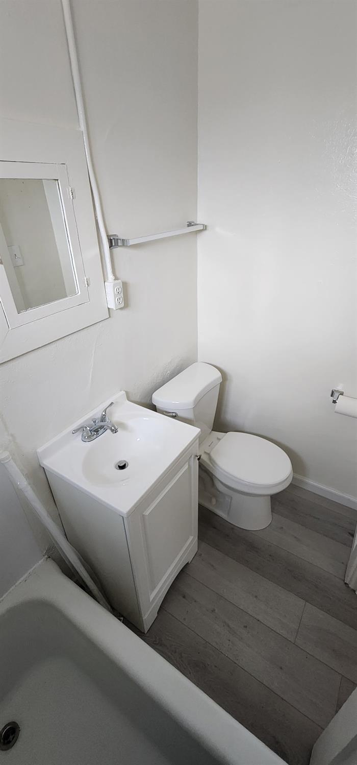 618 J Street Modesto, CA 95354 - Photo 38 of 38 a white toilet sitting next to a bathroom sink