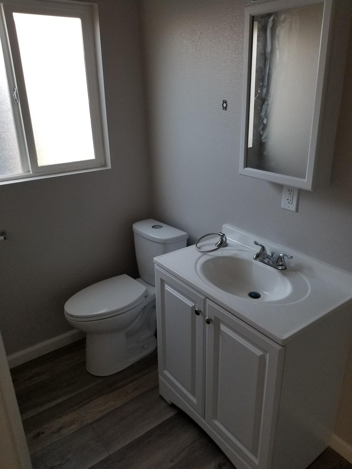 618 J Street Modesto, CA 95354 - Photo 4 of 38 a bathroom with a sink toilet and mirror