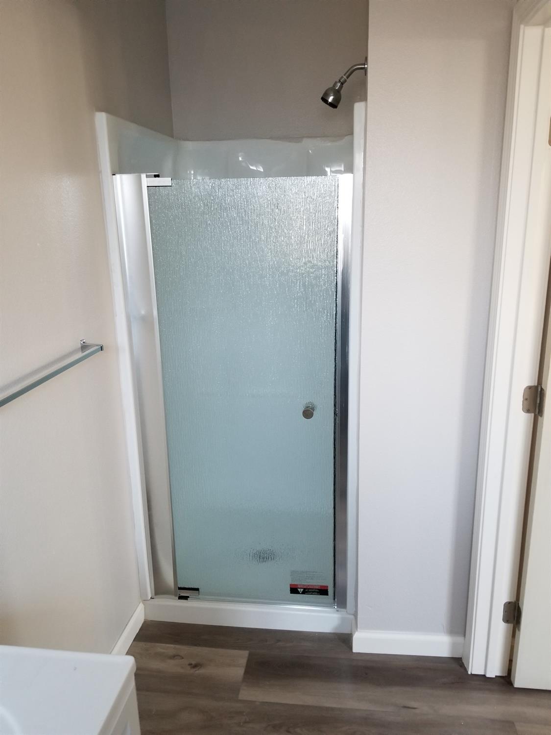 618 J Street Modesto, CA 95354 - Photo 5 of 38 a bathroom with a glass door shower and a sink