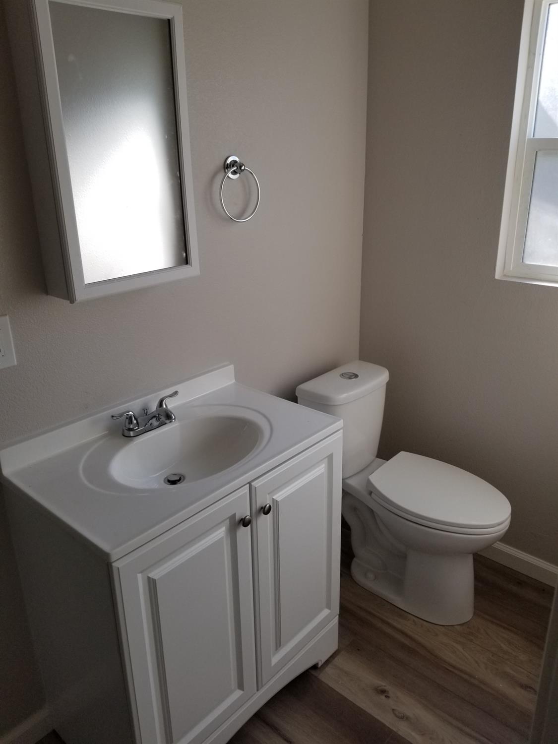 618 J Street Modesto, CA 95354 - Photo 8 of 38 a bathroom with a toilet sink and mirror